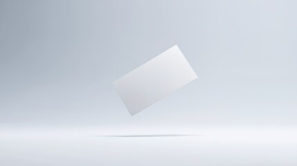 An elegant business card floating in mid-air against a clean, minimalist white background.