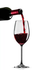 Red wine is gracefully poured into a stemmed glass, showcasing a rich, deep color.