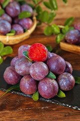 Fresh Purple Plums with Red Flesh on Rustic Wooden Background - Healthy Organic Stone Fruit Display