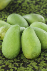 Fresh Raw Green Mangoes from Guangxi China on Moss Background - Tropical Fruit Harvest