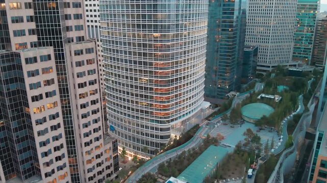 Aerial view of downtown San Francisco, California, USA, showcasing modern architecture and Salesforce Tower and park. The image highlights the city's skyline.