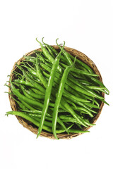 Fresh Green Chili Peppers in Wicker Basket on White Background