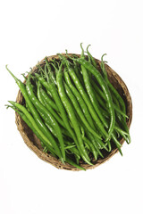 Fresh Green Chili Peppers in Wicker Basket on White Background