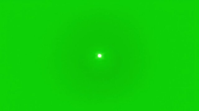 Bright light shines from a small point against a vibrant green background, evoking a sense of focus or discovery.