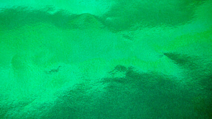 Vibrant green foil paper texture, abstract shiny background