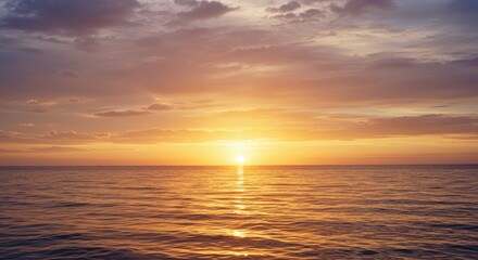 Obraz premium Serene Ocean Sunset with Golden Hues and Gentle Waves