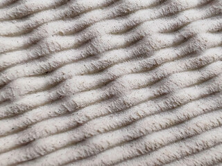Detailed Close-up of a White Shoe Midsole with a Ribbed Texture, Highlighting the Soft and Elastic Cushioning Technology.