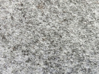 Grey abstract fibrous background, texture of felt fabric.