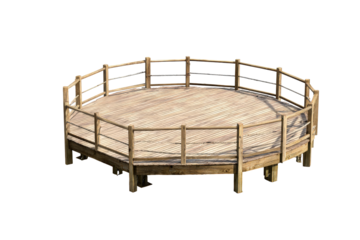 Empty rustic wooden round pen for equestrian training.