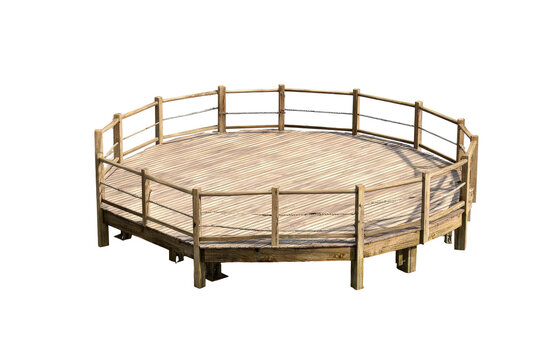 Empty rustic wooden round pen for equestrian training.
