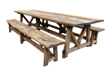 Long rustic weathered wooden picnic table with benches isolated.