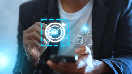 Businessman with target arrow virtual digital technology icon, business investment objectives and goals Marketing strategies and goals for success background panorama.