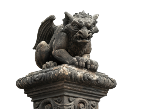 Ancient stone gargoyle statue with wings on a pedestal.