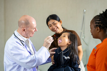 Caucasian doctor is diagnosis young girl using light inflammation, infection sore throat checkup...