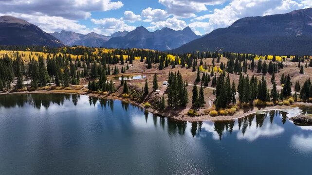 Scenic Colorado Landscape with a Lake Covered in Peak Fall Aspen Foliage Aerial