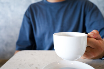 Clean Close-up Man Holding White Ceramic Coffee Cup at Cafe