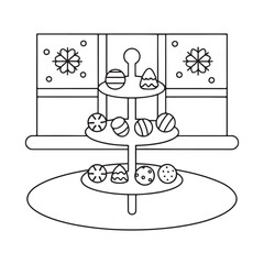 Tiered stand with assorted chocolates in front of a window with snowflakes candy sweet
