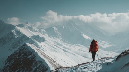 Mountaineer standing triumphantly on the summit of a majestic mountain overlooking a stunning landscape of snowy peaks and rugged alpine terrain under a clear blue sky, capturing the spirit of adventu