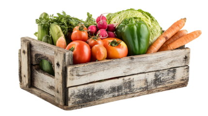 Fresh vegetables packed in a rustic wooden crate on white background.