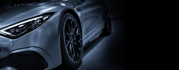 Front view of LED headlights sport car on black background is color blue tone 