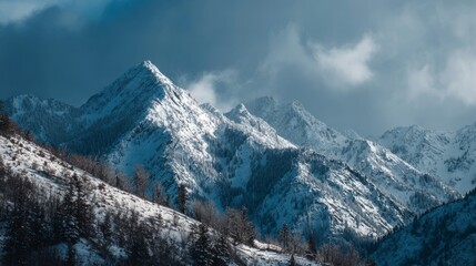 Epic winter landscape of snowy mountains in the french alps with dramatic high peaks and rocky cliffs piercing through rolling clouds under a clear sky, scenic alpine panorama for nature travel and ad