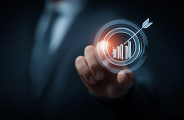 Businessman's hand holding a target and arrow icon with a digital graph