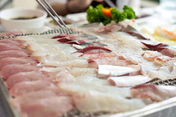 Fresh Korean Sashimi with Chopsticks in Seafood Restaurant