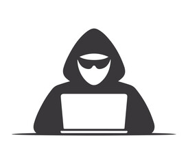 Anonymous hooded figure wearing sunglasses working on a laptop computer representing cybercrime