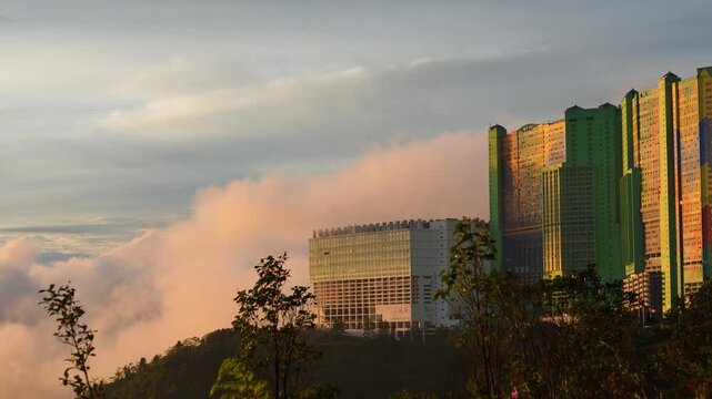 Genting highlands resort emerging from the clouds at dawn
