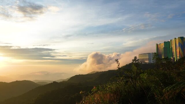 Sunrise illuminating lush mountain valley in genting highlands, malaysia