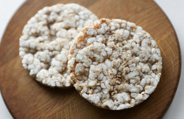 Rice round crackers, diet bread on wooden plate