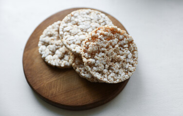 Rice round crackers, diet bread on wooden plate