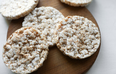 Rice round crackers, diet bread on wooden plate