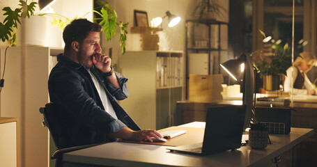 Tired man, yawn and laptop in office at night with burnout, work article and deadline. Person,...