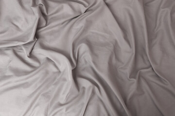 Texture of gray bed sheet, wavy fabric background
