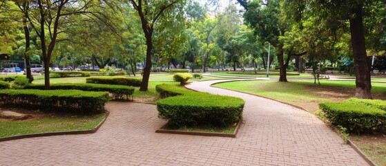 Obraz premium Modern Urban City Park with Brick Pavement and Greenery Premium Outdoor Space for Millennial Resilience and Summer Lifestyle Marketing Campaigns