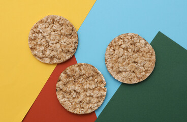 Rice round crackers, diet bread on colored background