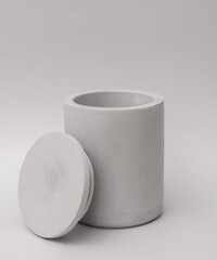 Concrete cup for candle on gray background