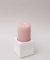 Concrete mold with candle on gray background