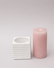 Concrete mold with candle on gray background