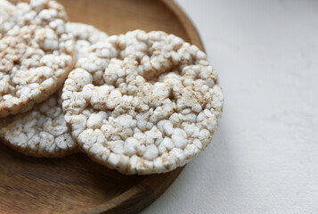 Rice round crackers, diet bread on wooden plate