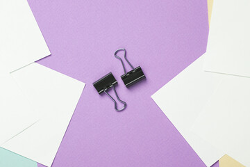 Paper binders on a pastel background