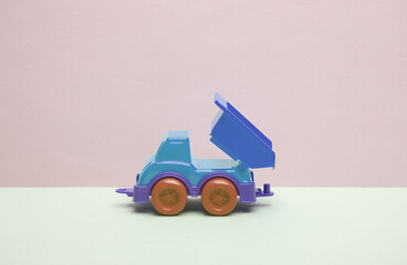 Toy dump truck on a pastel background