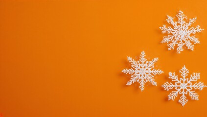 white snowflakes on vibrant orange background creating festive atmosphere