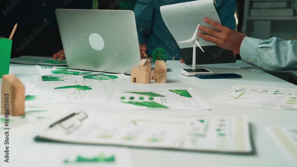 Poster professionals engage in a collaborative session, analyzing data and discussing sustainable solutions