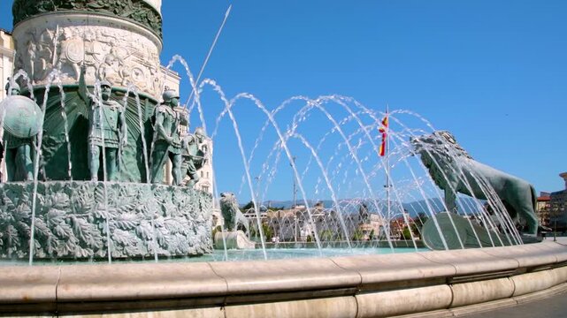Fountain in the center of Macedonia Square in Skopje with the North Macedonia flag in the background