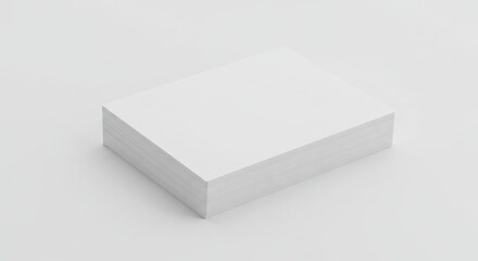 Fototapeta premium A neatly stacked pile of blank white paper sheets sits on a clean bright light gray surface casting subtle shadows