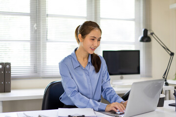 Female Office Worker Focused on Laptop Task