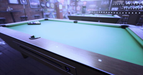 Players eagerly prepare for a game of billiards in a warm, welcoming bar. The atmosphere is lively, filled with anticipation, laughter, and the soft clinks of pool balls.