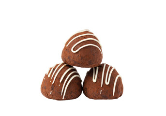 Isolated stack of three chocolate truffles with a white icing drizzle pattern on top food